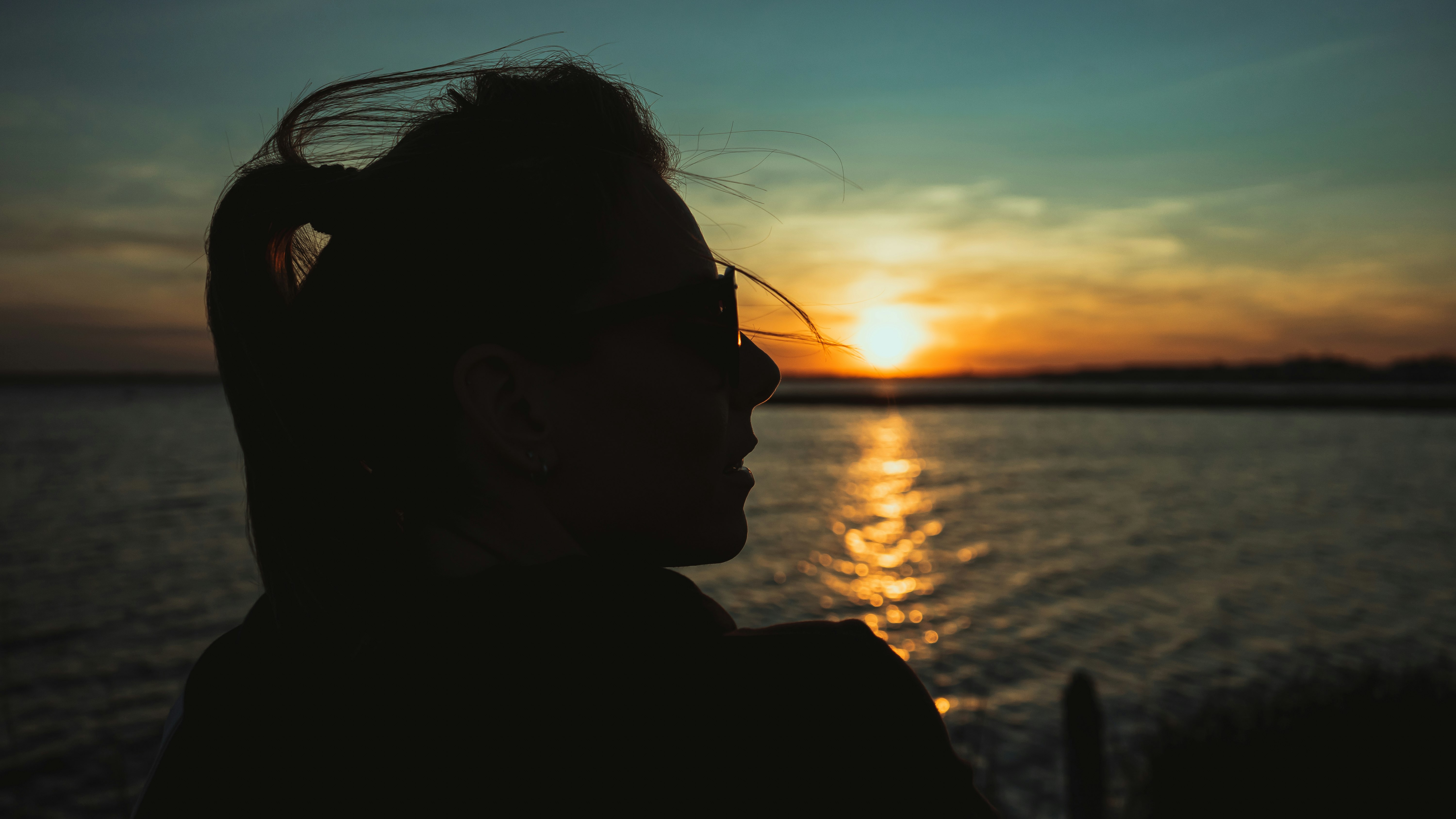 silhouette of man wearing sunglasses during sunset